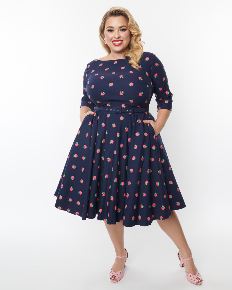 Front of a model wearing a size 2X/18 Unique Vintage Plus Size 1950s Navy & Strawberry Print Devon Swing Dress in Navy & Strawberry Print by Unique Vintage. | dia_product_style_image_id:269746